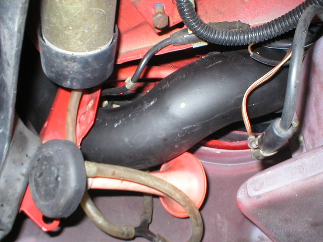 Intake snakes its way arround and through all kinds of doo-dads on it's way to it's filter. This is underneath the car, inside the front bumper and in front of the wheel.
