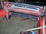 Removed the radiator bracketry to facilitate moving the rad forward in the chassis, and also the old hood latch support is gone to give room for the air intake plumbing.