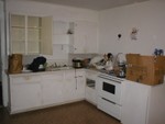 Kitchen looking at cabinets, stove and sink.