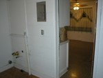 Looking from the pantry and laundry room into the kitchen dining area.