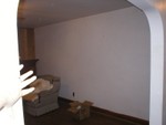 Looking through archway from kitchen/hallway into the livingroom. Notice how Leah is white enough to match the wall ;-D