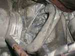 The starter sits inside the hole created by that arced engine mount bracket.