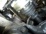 I took this just to show that somebody has replaced this CV boot or joint and failed to clean up the mess leaving axle grease sprayed all over the transmission and sub-frame.