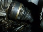 Closeup of the leaking CV joint. The leak is right behind the bolts in this shot where the boot meets the joint.