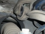 This one is so bad that it had shifted rearward and was cutting through it's mount. You can see just above the rubber bushing where the metal is shiney from being worn through.
