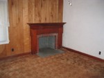 Living room fireplace. This is the wall opposite from the hallway entrance.