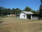 The workshop. On the right is a 3 sided carport, then in the center is the main room with a loft above, then to the left of the pic is another room.