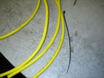 Start with a zip tire, your wires (this is usually done in the car), and some small diameter tubing or hose. For the hose the best thing to use is silicon hose, and you can get it in a ton of colors for better looks.

Cut the hose into small secions, about 10mm or 1/4 inch. You will need 1 piece between each wire, so 4 wires takes 3 sections of hose.